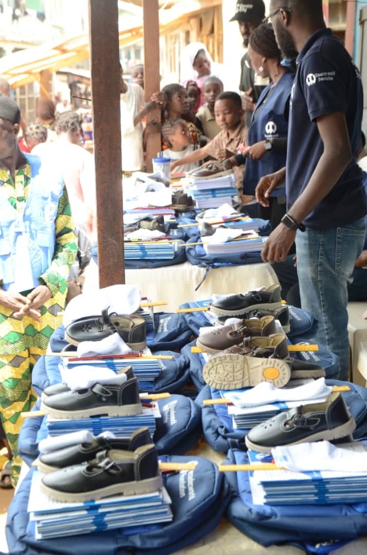 TosaadecWorld Foundation team distributing school shoes, bags, and supplies at a community outreach