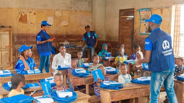 Children learning in a classroom, in uniform